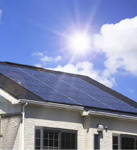 Solar panels on a sunlit house, harnessing renewable energy.